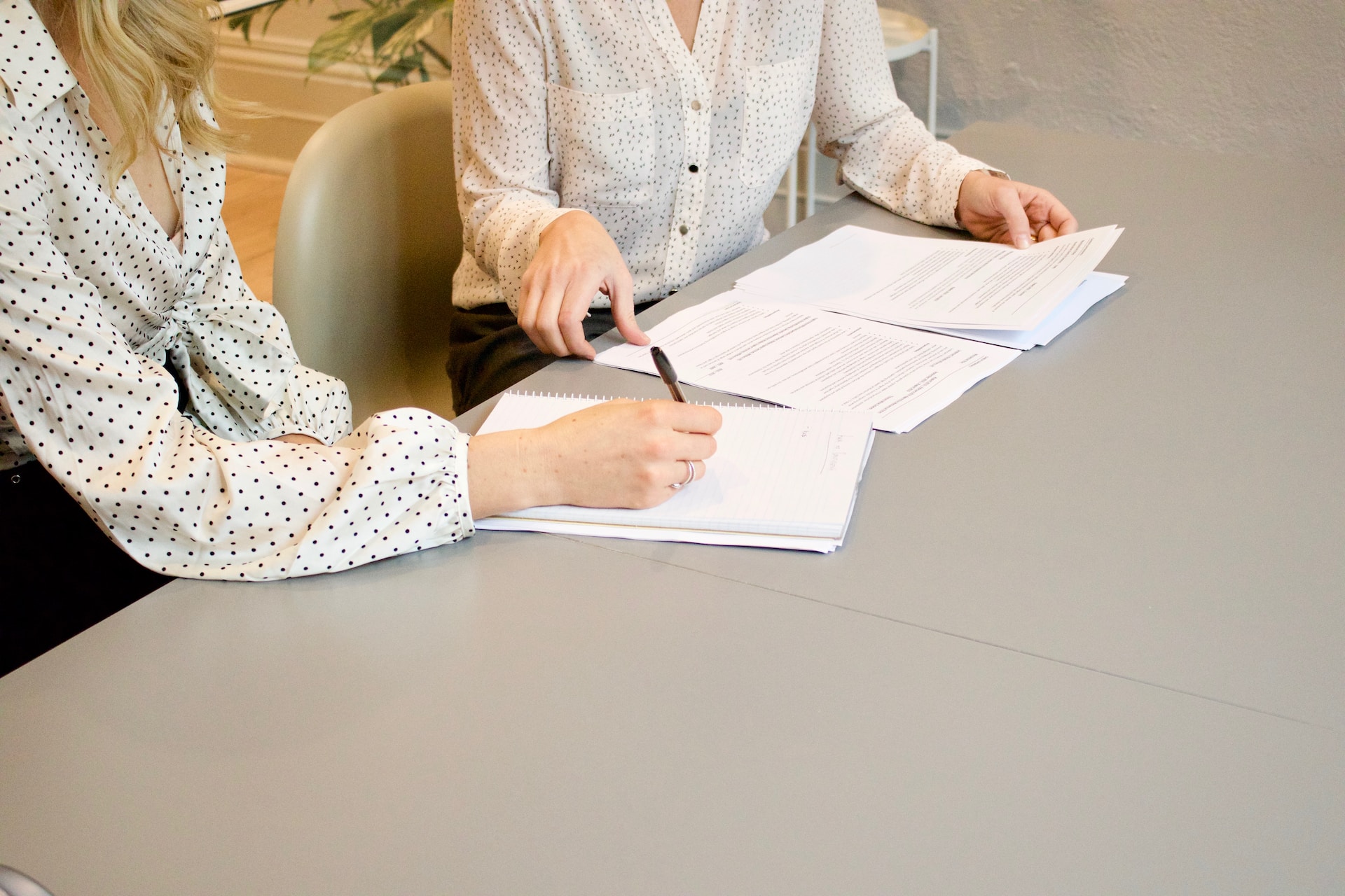Two women discussing important documents that may need to be notarized in Tampa, Florida.